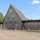 Large A-frame building on gravel lot (appears to be main office/clubhouse or amenity building) — shows facilities on site and matches images used on the site.  (Displayed on campground pages.)