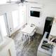 Interior view (loft-to-living) of a tiny-house cabin from the rooms page. Demonstrates sleeping/living layout and finishes available at the property.