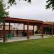 The covered clubhouse pavilion with tables and bougainvillea