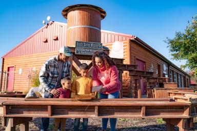 Family panning for gems at Old Faceful Mining Company at Jellystone Park™ South Haven