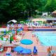 Large, clear photograph of the heated swimming pool and deck area with loungers — matches the ‘Heated Swimming Pool’ amenity image on the site (good overall facility view).