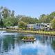 Pond with fountain and RVs along the water — highlights key scenic feature and adjacent RV sites. Matches gallery context (Pond View).