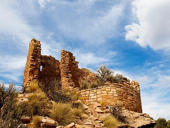 An ancient masonry structure under a bright blue sky