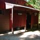 Exterior of restroom/showers building (Men/Women entrances) — shows on-site amenities and facilities available to campers. Source: About Us gallery.