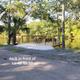 Concrete deck at waterfront lots #48–50 looking over the river with picnic seating — from the site’s lot photos and illustrates a typical waterfront campsite feature.