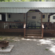 Exterior view of a rental camper with covered porch/deck — demonstrates on-site rental accommodations; from the Rental Campers page.