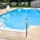 Outdoor swimming pool with fenced area and campground infrastructure visible in background — shows recreational facilities available on the property. Source: pool image on the site.
