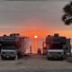 Framed sunset between two RVs looking directly at the water — strong, attractive campsite photo from the property gallery useful for listing.