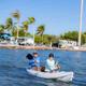 Couple kayaking off the coast of Big Pine Key in Florida with RV sites and palm trees in the background.