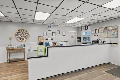 Front desk/office interior photograph showing reception counter and paperwork area — useful facility image from the property gallery.