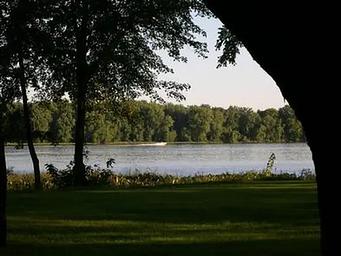 Looking at Mississippi River and a speedboat going by.