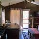 Interior view of the porch-cabin living area showing layout, kitchen and entry to deck — useful to illustrate cabin interiors for guests (rental unit page).