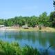 Lakefront view showing cabins, docks and a boat on the water — clear overview of the resort’s lake setting and shoreline amenities (matches resort property photos on listing page).