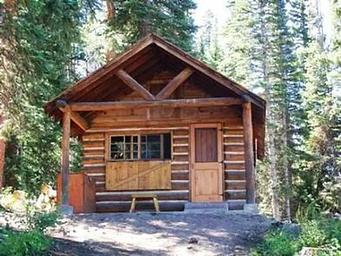 The front of a wooden cabin in a forest