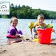 Children playing on the lake beach with shoreline and lake visible — useful beach/shore recreation shot shown in the site gallery.