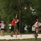 Photo of a basketball court in use with campers and RVs visible in the background — shows on‑site recreation facilities and activity areas. From the homepage slideshow.