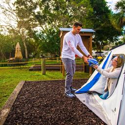 Tent campsite scene with adjacent campground features (picnic tables, shade trees, paths) — represents tent camping areas on the property. (waystostay photos).