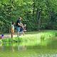 Scenic view of the pond with tree line and sky — represents campground’s waterfront/natural setting (gallery/pond photo on site).