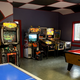 Arcade/recreation room with video games, pinball and pool table — interior facility photo useful for the campground’s amenities gallery.