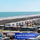 Coastal/aerial view demonstrating close walking distance to the beach and nearby accommodations — supports the property's beach-proximity claim on the site.