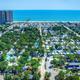 High, wide aerial view showing the campground layout, pier and nearby beachfront — good overall property overview (page gallery image).