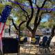 On-site campsite scene with RVs, shade trees, seating area and site surfaces — shows typical guest space and amenities (from the park gallery).