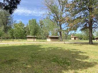 A group of sleeping cabins and vault toilet