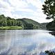 The Potomac River reflects a blue sky and fluffy clouds at McCoys Ferry