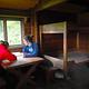 Two people at the table inside Sergief Island Cabin 