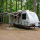 Clear photo of an RV on a gravel/wooded campsite with picnic table and hookups — shows typical RV site at Lebanon KOA (file sourced from the campground ‘ways to stay’ gallery on the property page).