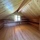 View of the loft inside the cabin with windows.