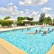 Outdoor swimming pool with lounge chairs and umbrellas — clearly depicts the campground's pool amenity and recreational setting (used on the property page).