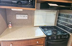 Large RV with outdoor kitchen, fireplace, and TVs