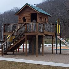Playground wooden play structure next to pool area — shows family amenities and play equipment (from Amenities page context).