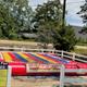 Image of the onsite Jump Pad attraction with signage and fencing — depicts a distinctive outdoor activity at this KOA visible in the activities gallery.