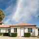 Exterior of a park building/apartment (tile roof, palms) that appears on the site (Apartment Rentals/Contact pages); helpful to show onsite housing/structures and architectural character.