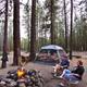 Tent site with fire ring and surrounding pines — good example of tent camping experience and campsite amenities (gallery/season pages).