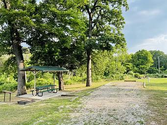 A photo of facility BUNCOMBE CREEK with Picnic Table, Electricity Hookup, Fire Pit, Shade, Water Hookup