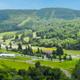 Wide panorama of the resort grounds including Hope Lake Lodge, surrounding hills and open areas. Useful as a property-level overview showing the campground's setting within the resort.