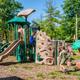 Playground area with climbing structures and children — demonstrates on-site recreational facilities and family-friendly amenities referenced on the activities sections.