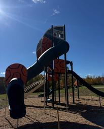 Photograph of an on-site playground structure with trees and open grounds visible — useful to show kid-friendly facilities available at the resort (found in the site’s gallery/promotional posts).