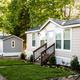 Exterior photograph of multiple tiny-house cabins on site (from 'Tiny House Cabins' rooms page). Shows cabin style, approach and landscaping.