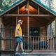 Small cabin on a wooded site with porch and site marker (S24) — useful depiction of on‑site cabin accommodation options (from Accommodations page).