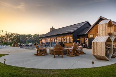 Outdoor patio/firepit seating area in front of the lodge/restaurant — shows communal facilities and dining/relaxation space on the property.