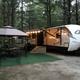 RV parked at a site with outdoor seating and canopy—good representation of RV accommodations and site setup; from the property’s photo gallery.