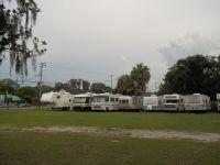 Another view of RV lots and grassy areas with hookups visible; useful for showing the camping area and site variety as presented on the park website.