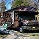 Single large RV on a dedicated site with picnic table and hookups visible; useful detail of an individual RV site and setup (site selection page image).