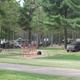 Open campsite area with playground and multiple RVs visible — shows family/RV section and on-site amenities (from photo gallery).
