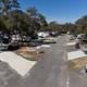 Ground-level aerial/street-facing view showing concrete RV pads, hookups and road—good for conveying typical site appearance (from gallery).