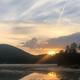 Lakeside sunset over a small dock and shoreline — matches multiple ‘Activities’/homepage images on the site depicting Forest Lake views and evening scenery.